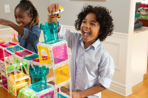 Boy screaming with delight as he plays with Squaregles