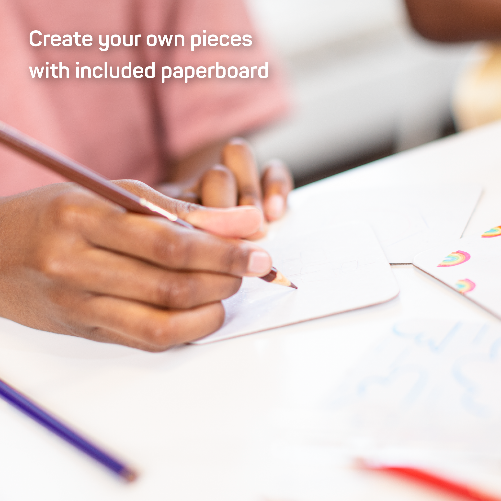 Kid drawing on paperboard panel with text that says "Create your own pieces with included paperboard"