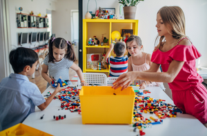Group of children playing with LEGO bricks in a house