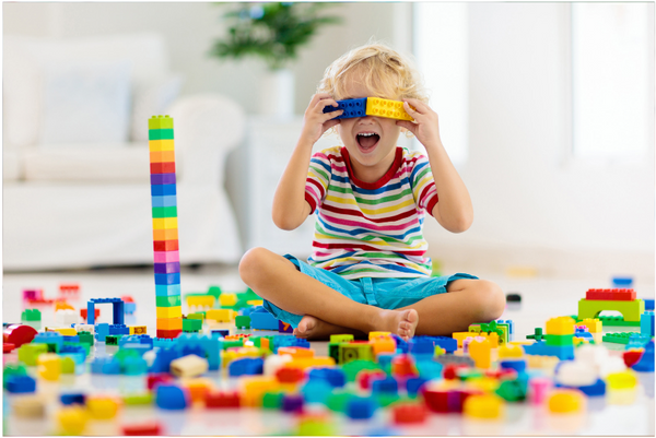 Boy playing with building blocks in a living room