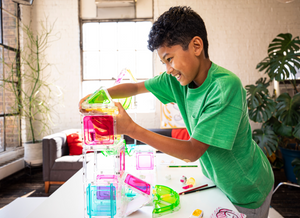 Boy placing Squaregles pieces on a build in a living room