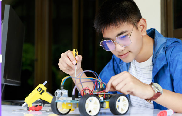 Boy putting together electric car toy